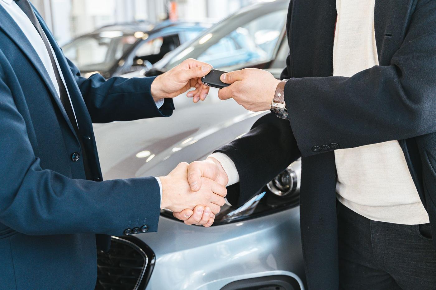 Customer receiving car keys at a used car dealership